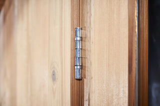 Close up of metal sauna door hinge