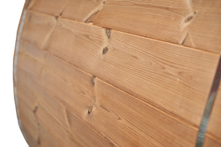 Side view of the Immerse brand barrel sauna showing the wood grain and knots