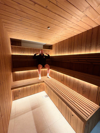 Immerse founder Alex in a wooden sauna with illuminated benches