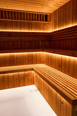 Wooden Finnish sauna interior with floor drainage and LED lighting