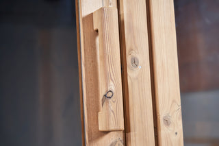 Close up of wooden sauna handle accessory fitted to door