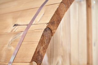 The outer edge of a Finnish barrel sauna close up to see the grain