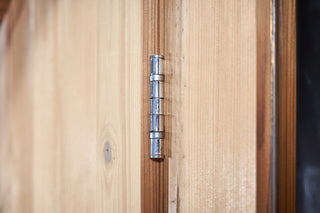 Close up of metal sauna door hinge 