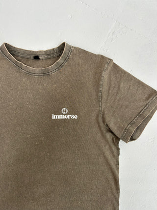 Close-up of acid wash texture on crew neck t-shirt laid out – each piece individually dyed